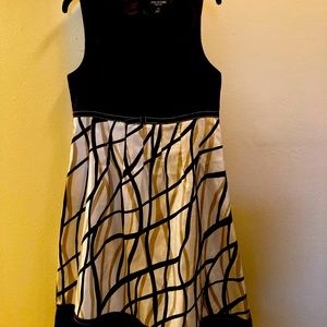 Sleeveless A line dress with small bow detail.